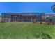Enclosed backyard pool with spacious grassy area, perfect for outdoor relaxation and entertaining at 12800 Solola Way, Trinity, FL 34655