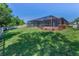Expansive backyard with lush green grass and a screened enclosure provides ample outdoor space at 12800 Solola Way, Trinity, FL 34655