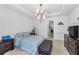 Well-lit bedroom with a tray ceiling, a chandelier, and neutral carpeting, creating a serene atmosphere at 12800 Solola Way, Trinity, FL 34655