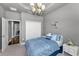 Relaxing bedroom with a chandelier, closet, neutral carpet, and stylish decor at 12800 Solola Way, Trinity, FL 34655