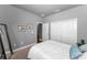 Neutral bedroom with a large double closet and artwork at 12800 Solola Way, Trinity, FL 34655