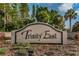 Community entrance sign for Trinity East surrounded by lush landscaping at 12800 Solola Way, Trinity, FL 34655