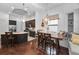 Open dining area featuring dark wood table, pendant lighting, and kitchen access at 12800 Solola Way, Trinity, FL 34655