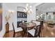Dining room with elegant lighting, hardwood floors, built-in cabinetry, and an open layout perfect for entertaining at 12800 Solola Way, Trinity, FL 34655