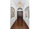 Elegant foyer with dark wood flooring, double doors, chandelier and decorative wall accents creating a grand entrance at 12800 Solola Way, Trinity, FL 34655