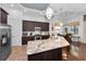 Open kitchen with stainless steel appliances, granite countertops, and breakfast bar with pendant lighting at 12800 Solola Way, Trinity, FL 34655