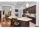 Modern kitchen featuring granite countertops, stainless steel appliances, dark wood cabinetry, and a breakfast bar at 12800 Solola Way, Trinity, FL 34655