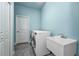 Functional laundry room with modern appliances and a deep utility sink at 12800 Solola Way, Trinity, FL 34655