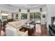 Living room featuring sliding glass doors leading to the pool, ample seating, and a ceiling fan at 12800 Solola Way, Trinity, FL 34655