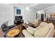 Open living room features a TV, elegant furniture, and access to the dining room at 12800 Solola Way, Trinity, FL 34655