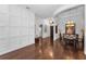 Spacious living area featuring hardwood floors, decorative wall trim, elegant lighting, and seamless flow to dining area at 12800 Solola Way, Trinity, FL 34655
