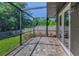 Screened lanai with brick pavers and view of the backyard offers private outdoor living at 12800 Solola Way, Trinity, FL 34655
