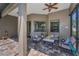 Covered patio with comfortable seating area, overlooking garden and pool at 12800 Solola Way, Trinity, FL 34655