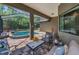 Inviting screened-in patio with comfortable seating and a view of the pool and lush landscaping at 12800 Solola Way, Trinity, FL 34655