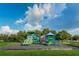 Community playground with slides and climbing structures with green space at 12800 Solola Way, Trinity, FL 34655