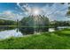 Picturesque pond reflecting the surrounding lush trees in the community at 12800 Solola Way, Trinity, FL 34655