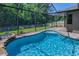 Inviting swimming pool with screened enclosure, complemented by lush backyard landscaping at 12800 Solola Way, Trinity, FL 34655
