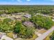 Beautiful aerial view of the property, highlighting the manicured lawn, mature trees, and peaceful neighborhood at 13469 Pia Ct, Spring Hill, FL 34609