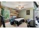 Bedroom with camouflage accent wall, ceiling fan, and closet at 13469 Pia Ct, Spring Hill, FL 34609