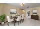 Elegant dining room with a stylish table set, a modern light fixture, and contemporary wall art at 13469 Pia Ct, Spring Hill, FL 34609