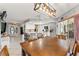 Open dining room area with decorative hanging light and view into kitchen at 13469 Pia Ct, Spring Hill, FL 34609