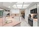 Bright kitchen with white cabinets, tile flooring, and modern appliances, perfect for cooking and entertaining at 13469 Pia Ct, Spring Hill, FL 34609