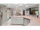 Bright kitchen with white cabinets, tile flooring, and a view of the backyard through the sliding glass doors at 13469 Pia Ct, Spring Hill, FL 34609
