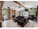 Comfortable living room with a brick fireplace, ceiling fan, and ample space for relaxing and entertaining at 13469 Pia Ct, Spring Hill, FL 34609