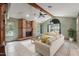 Bright living room with a brick fireplace, vaulted ceilings, and large windows at 13469 Pia Ct, Spring Hill, FL 34609