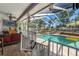 Inviting screened-in pool area with outdoor seating and a relaxing waterfall feature at 13469 Pia Ct, Spring Hill, FL 34609