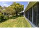 Expansive backyard featuring a screened-in patio and mature landscaping, creating a private and serene outdoor oasis at 14105 Agua Clara Dr, Hudson, FL 34667