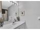 Bright bathroom featuring a large mirror, vanity with sink, and stylish decor at 14105 Agua Clara Dr, Hudson, FL 34667