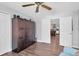 Bedroom featuring wood floors, a closet, and an open door into the kitchen at 14105 Agua Clara Dr, Hudson, FL 34667