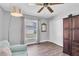 Cozy bedroom features a ceiling fan, wood floors, closet, and a window with natural light at 14105 Agua Clara Dr, Hudson, FL 34667