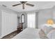Bright bedroom with wood floors, a closet, and a ceiling fan at 14105 Agua Clara Dr, Hudson, FL 34667