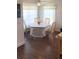 Bright dining area featuring a table with seating for four under a ceiling fan and large windows at 14105 Agua Clara Dr, Hudson, FL 34667
