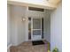 Inviting entryway with brick flooring, screen door, and modern light fixture at 14105 Agua Clara Dr, Hudson, FL 34667