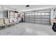 Spacious garage with overhead door, shelving for storage, and ample room for vehicles at 14105 Agua Clara Dr, Hudson, FL 34667