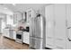 Modern kitchen featuring stainless steel appliances, white cabinets, and stylish backsplash at 14105 Agua Clara Dr, Hudson, FL 34667