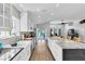 Bright, modern kitchen with a large island, stainless steel appliances, and an open layout to the living room at 14105 Agua Clara Dr, Hudson, FL 34667