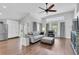 Bright living room features wood floors, a ceiling fan, and access to the patio at 14105 Agua Clara Dr, Hudson, FL 34667