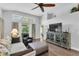 Cozy living room with high ceilings, hardwood floors, and natural light at 14105 Agua Clara Dr, Hudson, FL 34667