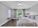 Comfortable main bedroom with large window overlooking backyard at 14105 Agua Clara Dr, Hudson, FL 34667