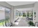 Bright sunroom with tile flooring and multiple windows with outdoor views at 14105 Agua Clara Dr, Hudson, FL 34667