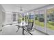 Screened lanai with a ceiling fan provides natural light and views of the yard at 14105 Agua Clara Dr, Hudson, FL 34667