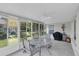 Enclosed lanai offers outdoor views, a ceiling fan, and is setup for dining at 14105 Agua Clara Dr, Hudson, FL 34667