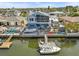Aerial view of waterfront property with boat docks, lush landscaping and canal access at 15535 Allmand Dr, Hudson, FL 34667