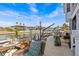 Canal backyard with patio, comfortable seating, boat lift, and serene water views at 15535 Allmand Dr, Hudson, FL 34667