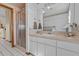Bathroom featuring a long countertop, shower, and decorative wallpaper at 15535 Allmand Dr, Hudson, FL 34667
