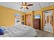 Bright bedroom with a ceiling fan, closet, and view from the window at 15535 Allmand Dr, Hudson, FL 34667
